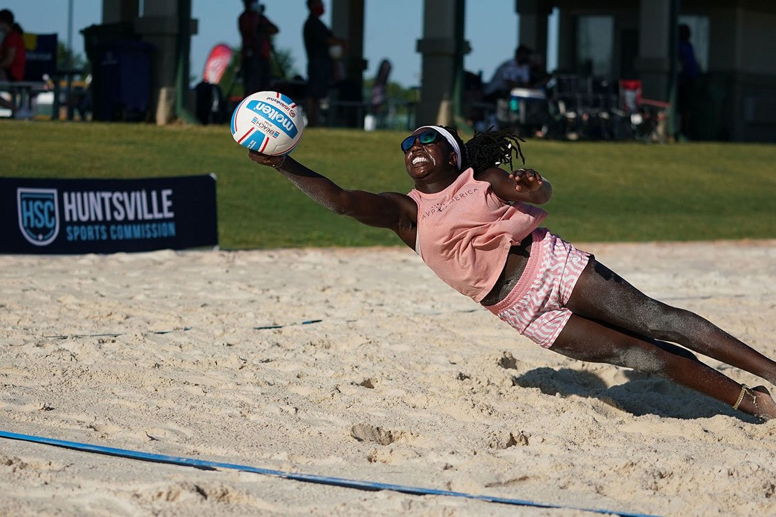 Beach Volleyball Player diving for the ball