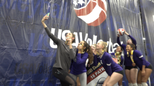 Hallie Enderle and her team (NIVA 18X) celebrate with a selfie on the championship stage at GJNC 18s.