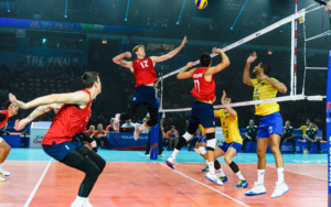 U.S. Men's National Team middle Max Holt getting ready to attack a ball set to him from teammate Micah Christenson versus Brazil at the 2019 Volleyball Nations League tournament.