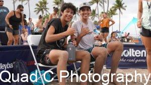 Boys giving hang loose sign at beach tournament