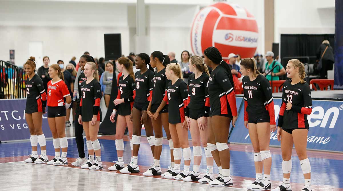 Girls volleyball players line up to begin play