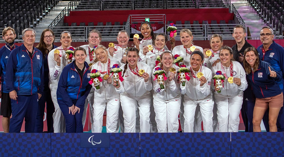 U.S. Women's Sitting Team holding gold medals at the Paralympic Games