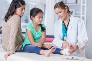 A parent and child consulting a doctor