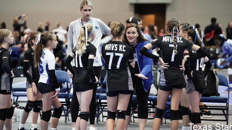 Female coach talking to team on sidelines