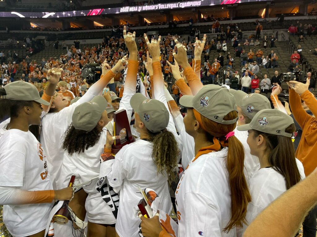 Texas players in a huddle after winning