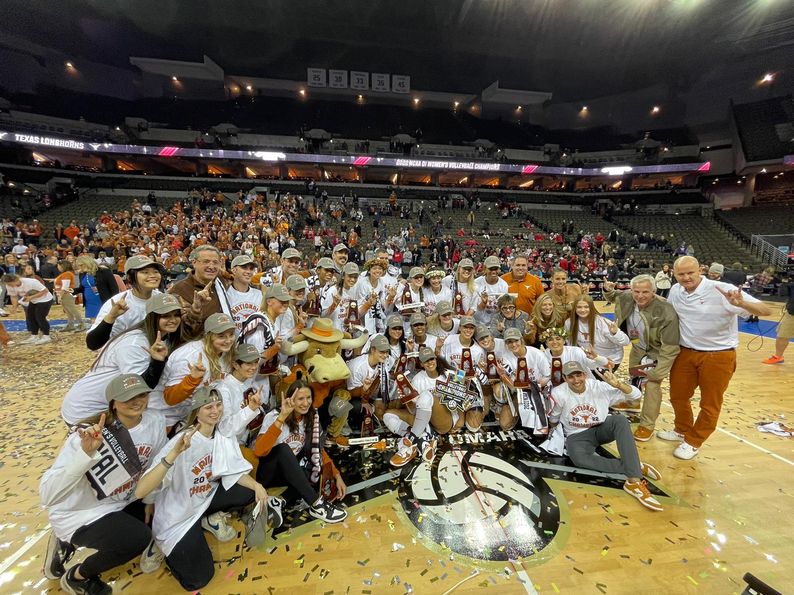 Texas players and coaches pose with the NCAA trophy