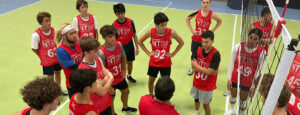 Boys listening to a coach on the court