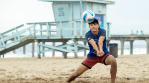 Boy playing volleyball on the beach