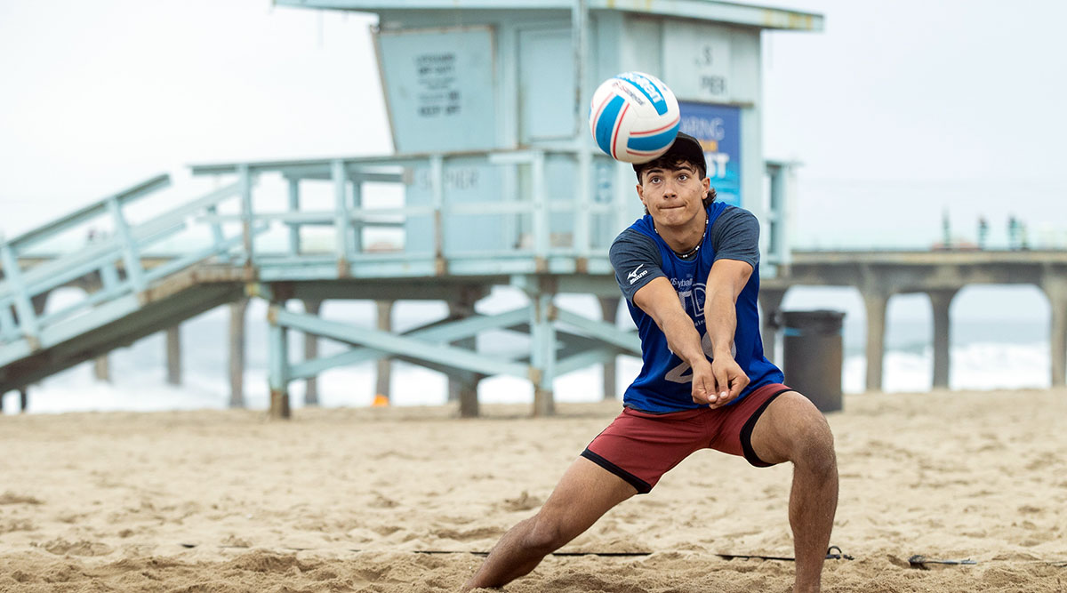 Boy playing volleyball on the beach
