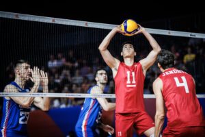 Micah Christenson setting in U.S. win over Serbia.