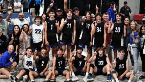 A boys team and parents pose