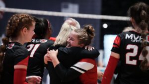 Two girls hug on the court