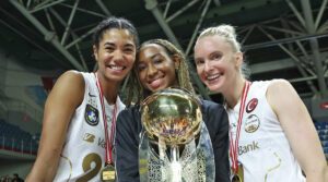 Jordan Thompson, Chiaka Ogbogu and Ali Frantti wear medals and hold a large trophy
