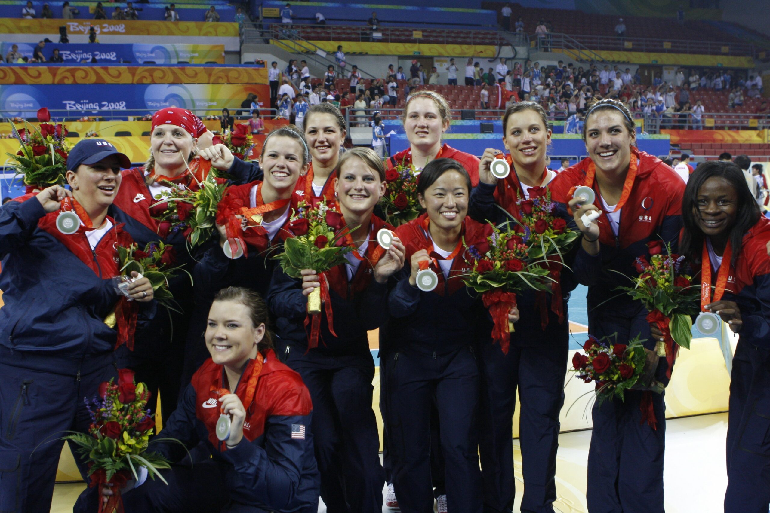 The 2008 U.S. Women's Paralympic Sitting Volleyball team members pose for a photo with their silver medals.