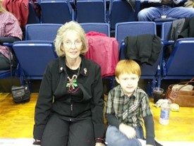 Kay Brown poses for a photo with a young boy.