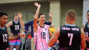 A male player on Team YoYo waves to the crowd