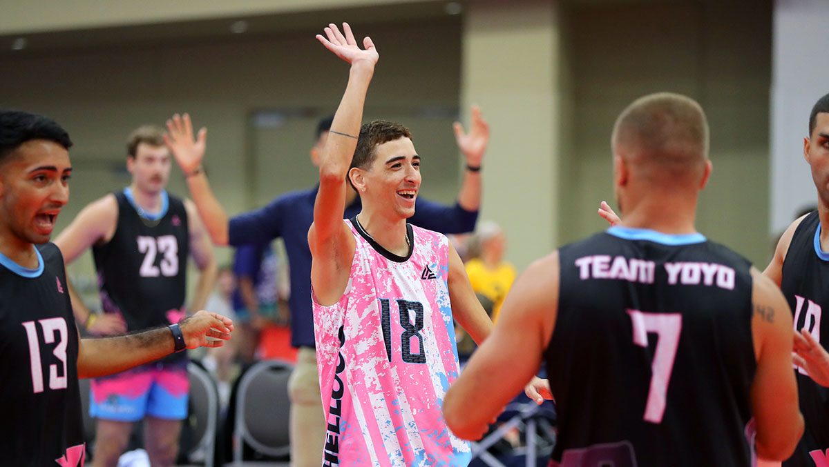 A male player on Team YoYo waves to the crowd