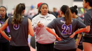 A female coach talks to her team of women