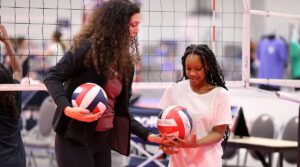 A female coach talks to a young girl