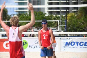 Caleb Blanchette celebrates on the beach
