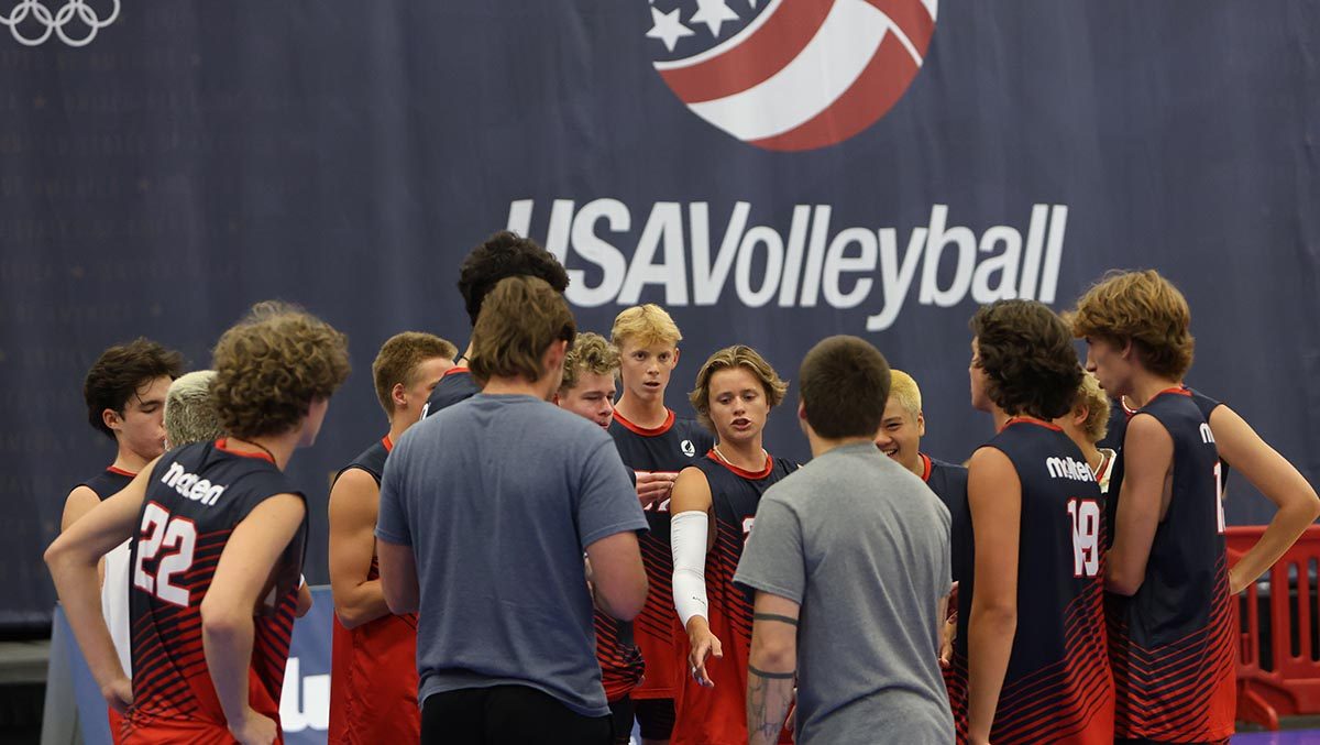 Boys gather around a coach
