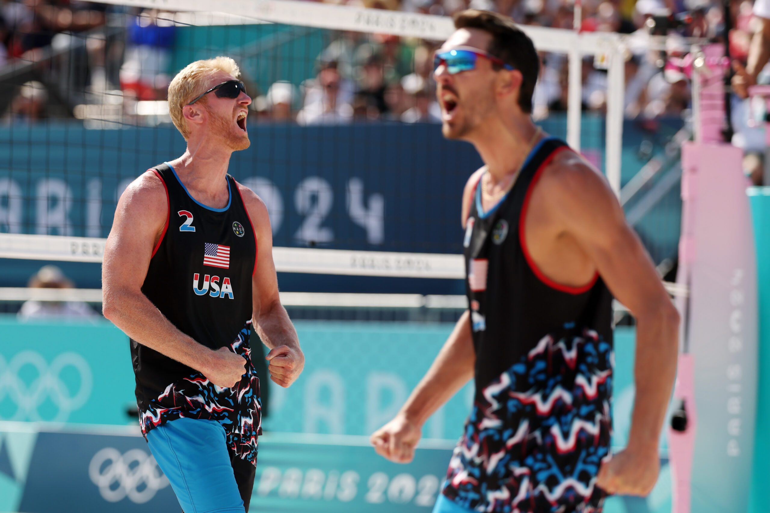PARIS, FRANCE - JULY 29: Chase Budinger and Miles Evans of Team United States celebrate during the Men's Preliminary Phase - Pool F match against Team France on day three of the Olympic Games Paris 2024 at Eiffel Tower Stadium on July 29, 2024 in Paris, France. (Photo by Michael Reaves/Getty Images)