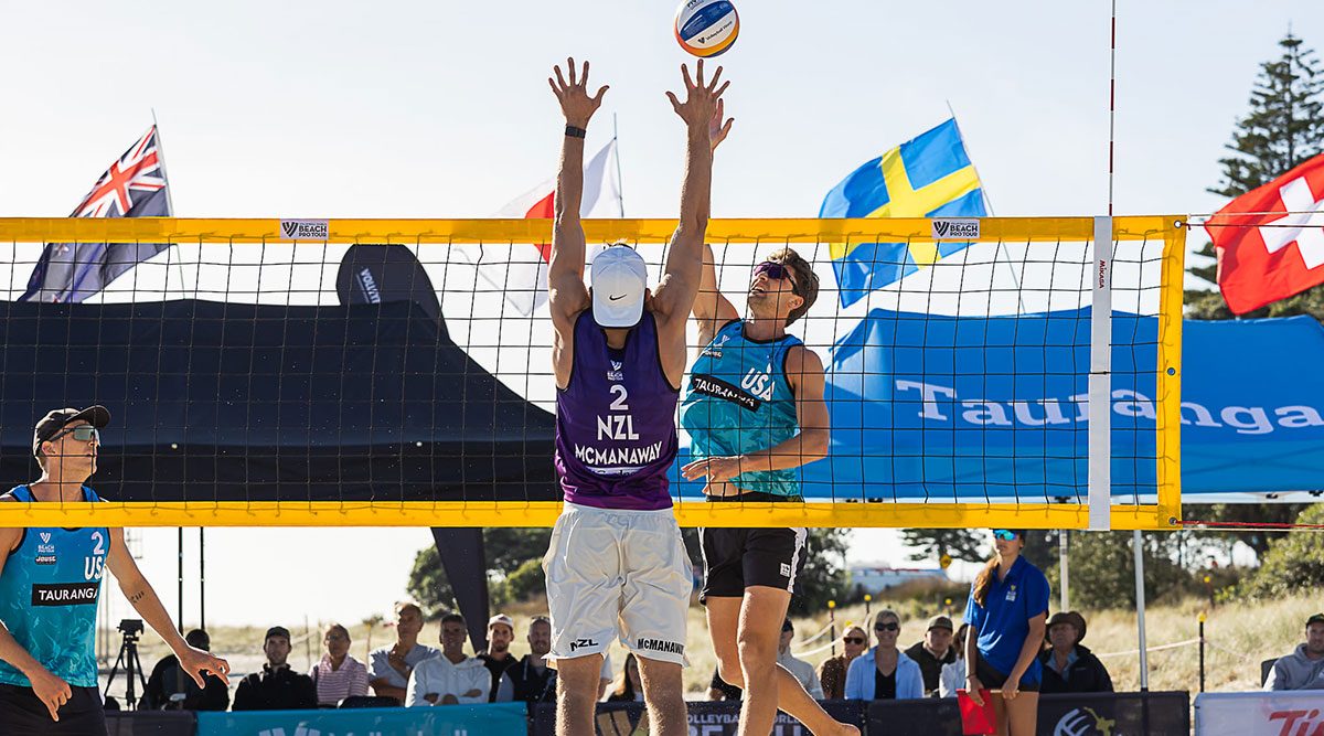 Men's teams playing beach volleyball