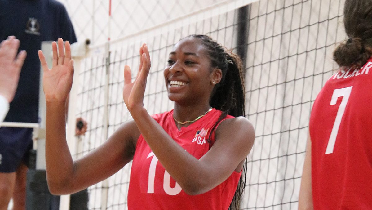 A college player in USA gear high fives a teammate