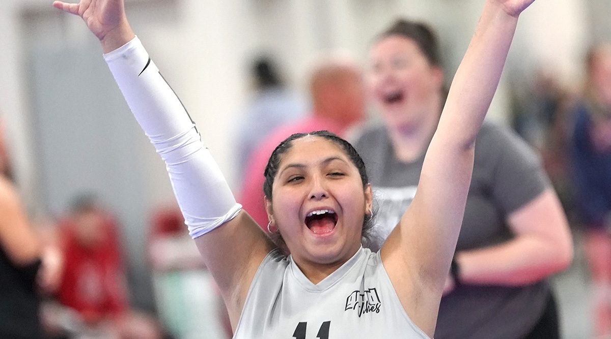 A girls volleyball player celebrates