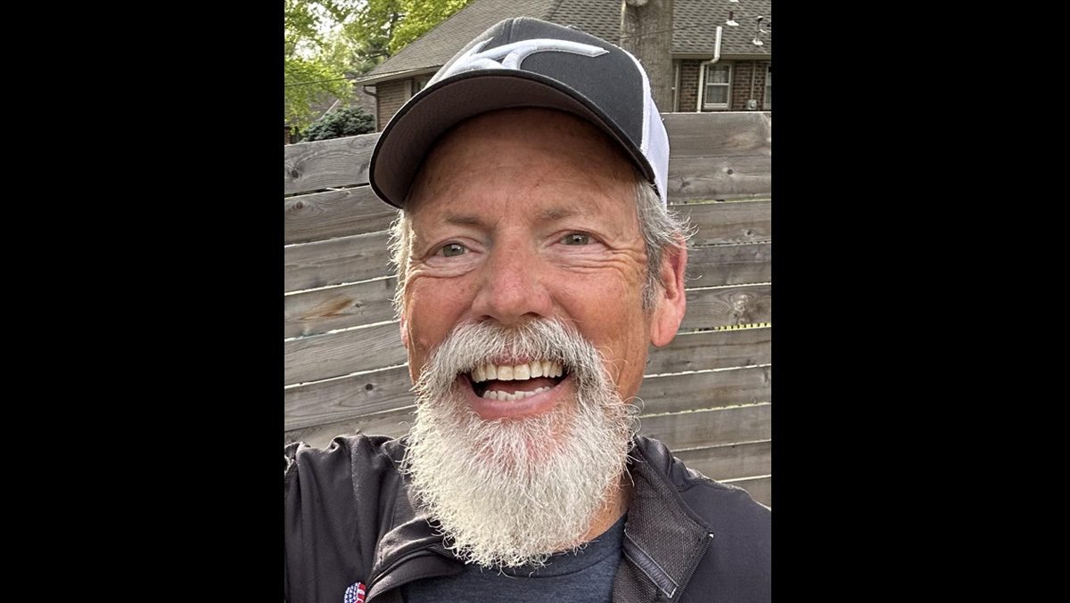 Bill Forrester smiles at the camera in a Mizuno hat and USA Volleyball jacket