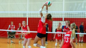 A female athlete sets the ball at girls spring training