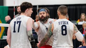 John Kremer celebrates with Zach Upp and James Stuck
