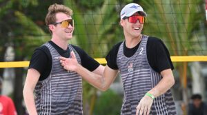 Gage Basey and Thomas Hurst celebrate on the sand