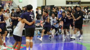 A boys team celebrates on the court