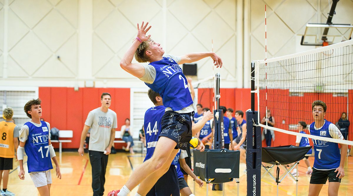 A boys player goes up for a spike