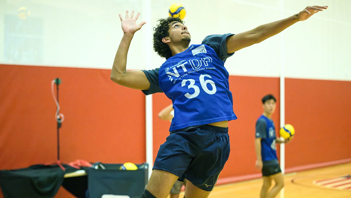 Sean John goes up for a serve at boys ntdp fall training