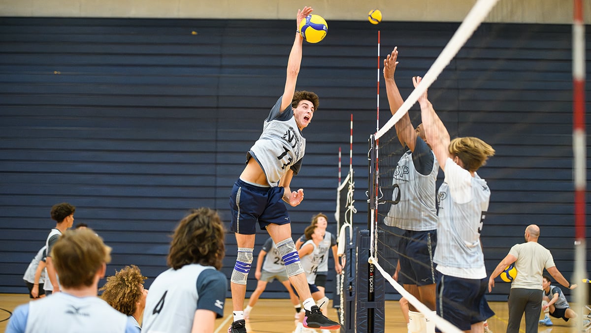 A boys player attacks hte ball wearing an ntdp pinnie