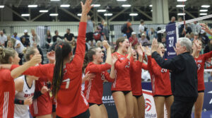 A girls team celebrating on the court