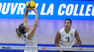 Micha Hancock sets while Avery Skinner looks on