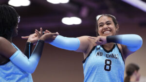 Two girls celebrate with each other