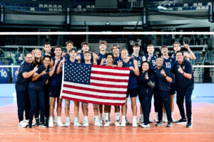 The U.S. Men's U23 National Team poses with a flag to celebrate winning gold.