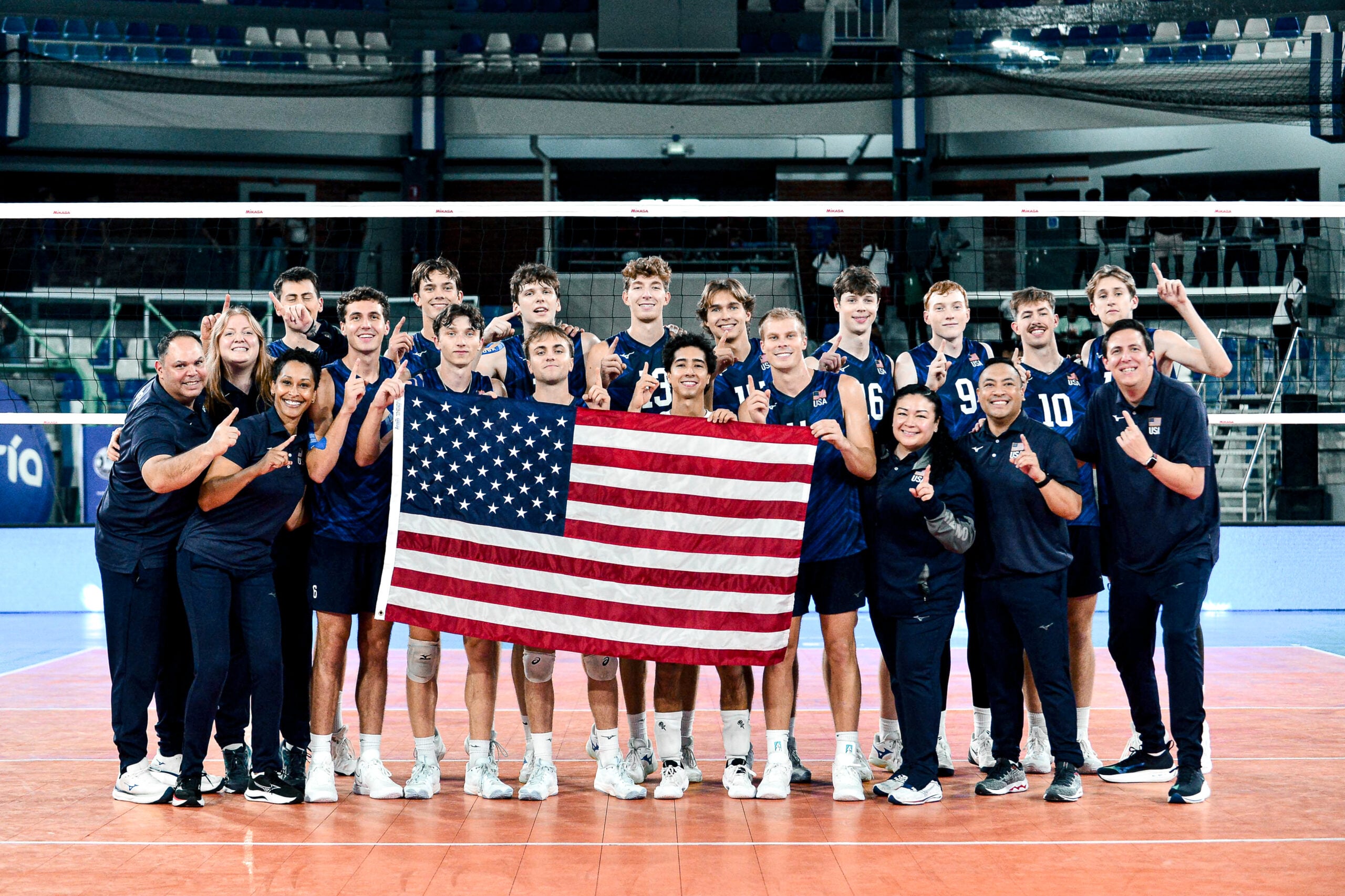 The U.S. Men's U23 National Team poses with a flag to celebrate winning gold.