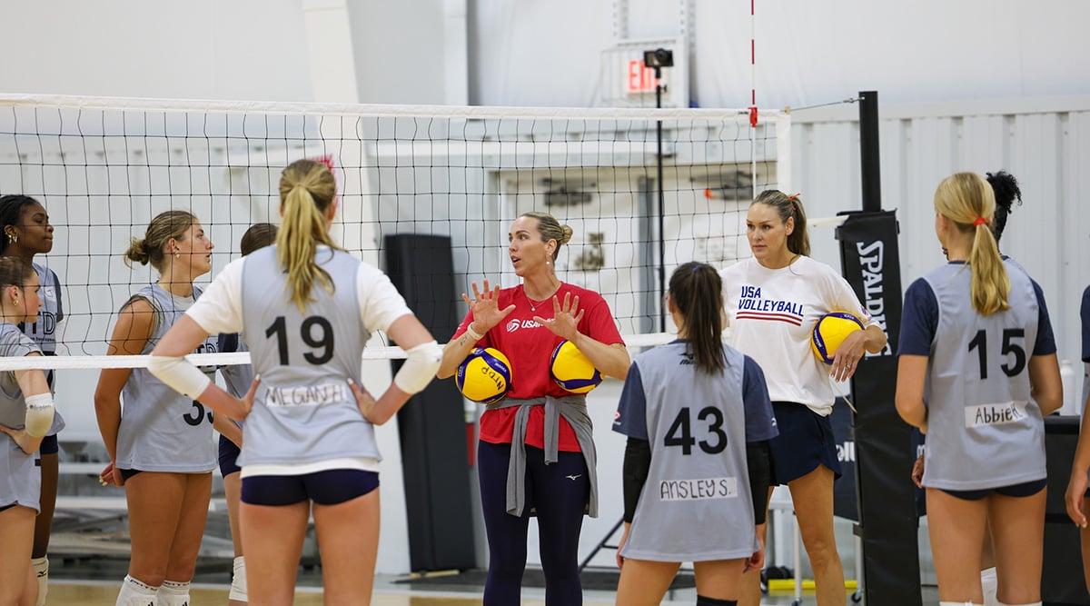 A group of girls athletes listen to a coach at the NTDP Training Series